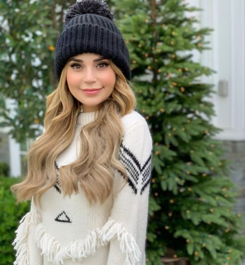 Rosanna Pansino poses a picture wearing a white sweater.